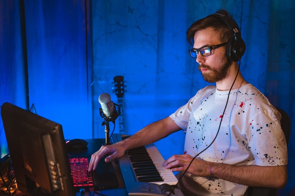 Musician wearing an headset creating music online