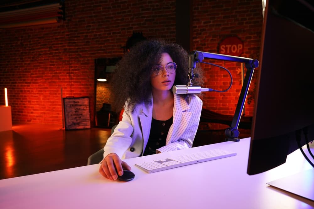 Woman in studio creating music on a computer